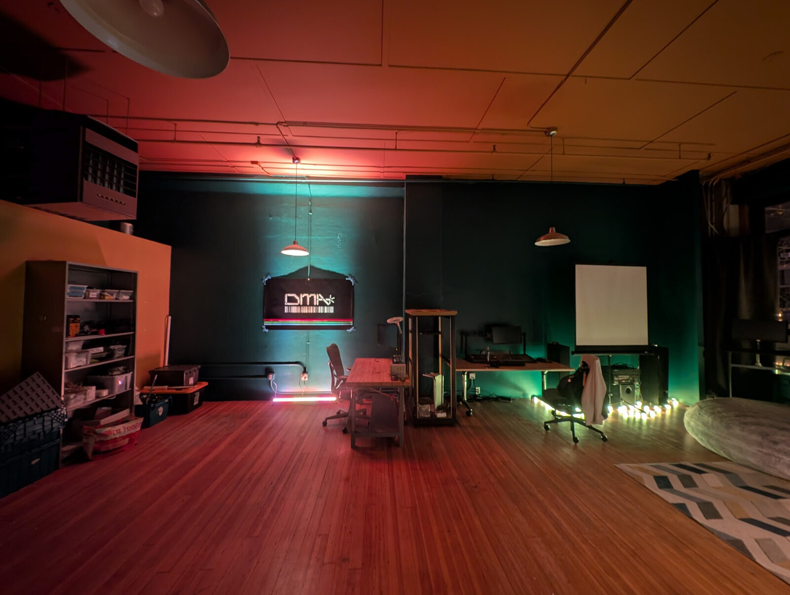 The space at night, with colorful LED lights illuminating the room.